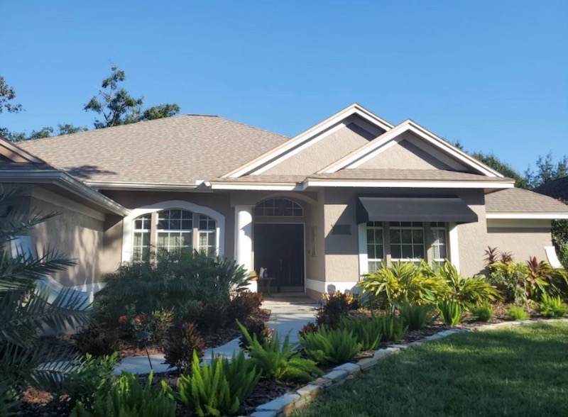 A home with a large front yard and landscaping.
