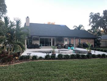 A home with a pool and landscaping.