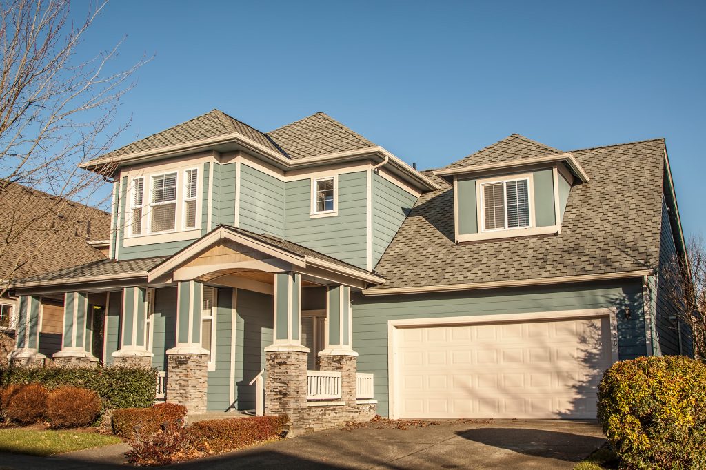 A house with blue siding and a garage.