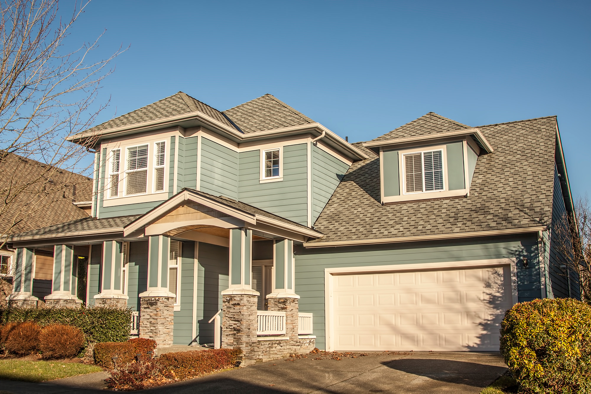 A house with blue siding and a garage.
