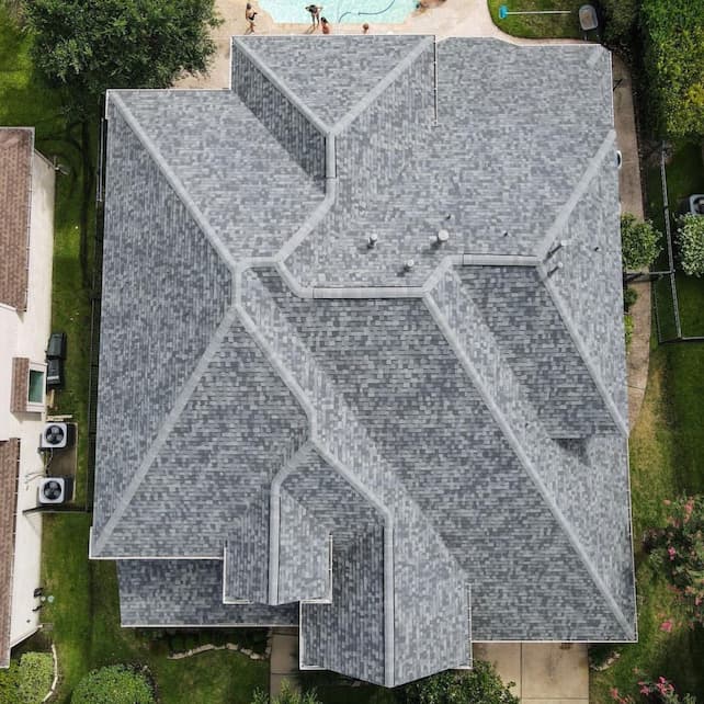 An aerial view of a house with a shingled roof done by Marathon Roofing & Contracting in Port Orange, FL